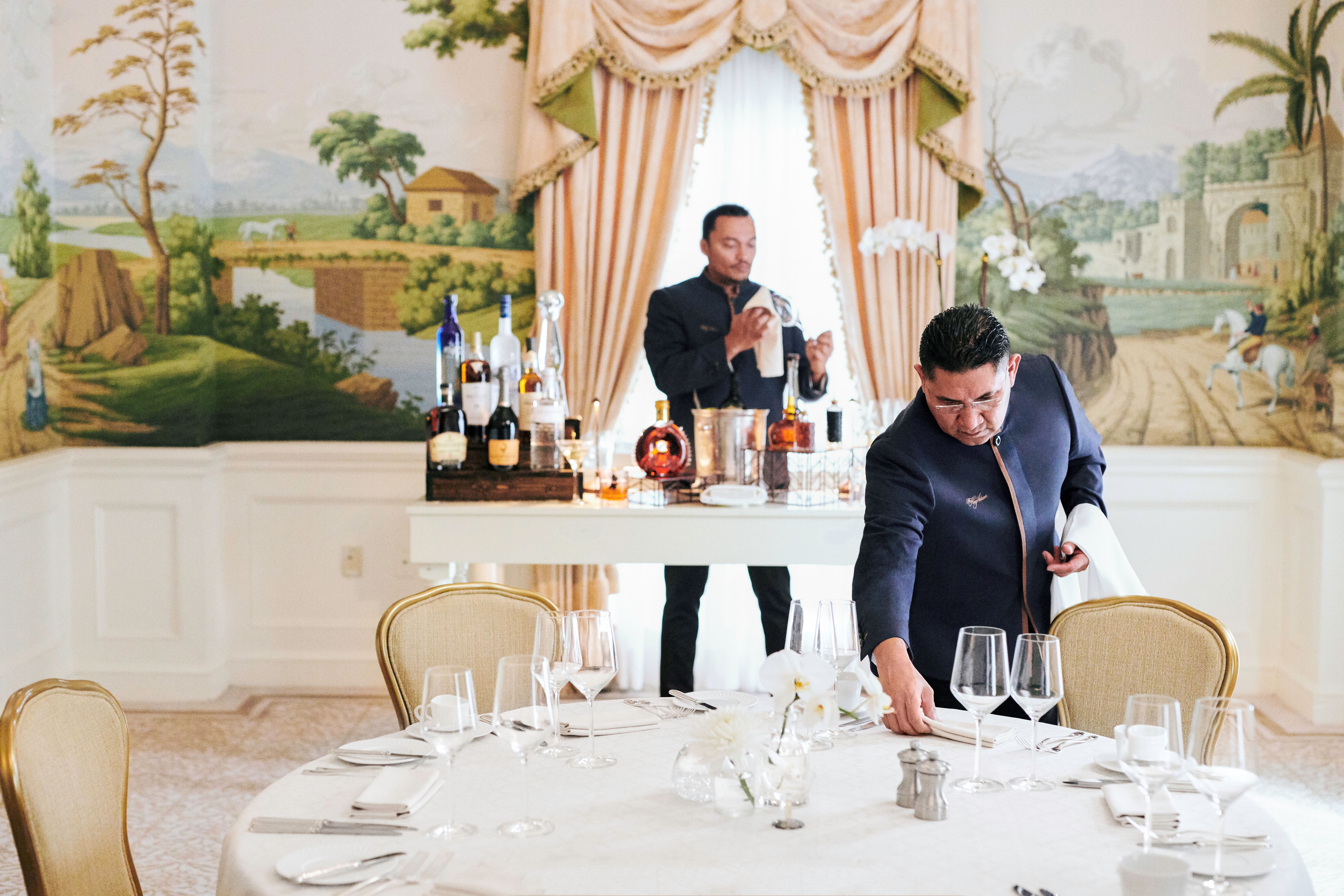 a waiter setting a table in a dining room