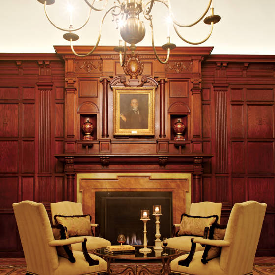 The $900,000 structure opens, featuring Doric, Ionic, and Corinthian orders, walnut wainscoting, and intricate ceiling treatments with Elizabethan and Tudor motifs. Wood paneling from the Hay residence is repurposed in the space now known as the Hay-Adams Room. 