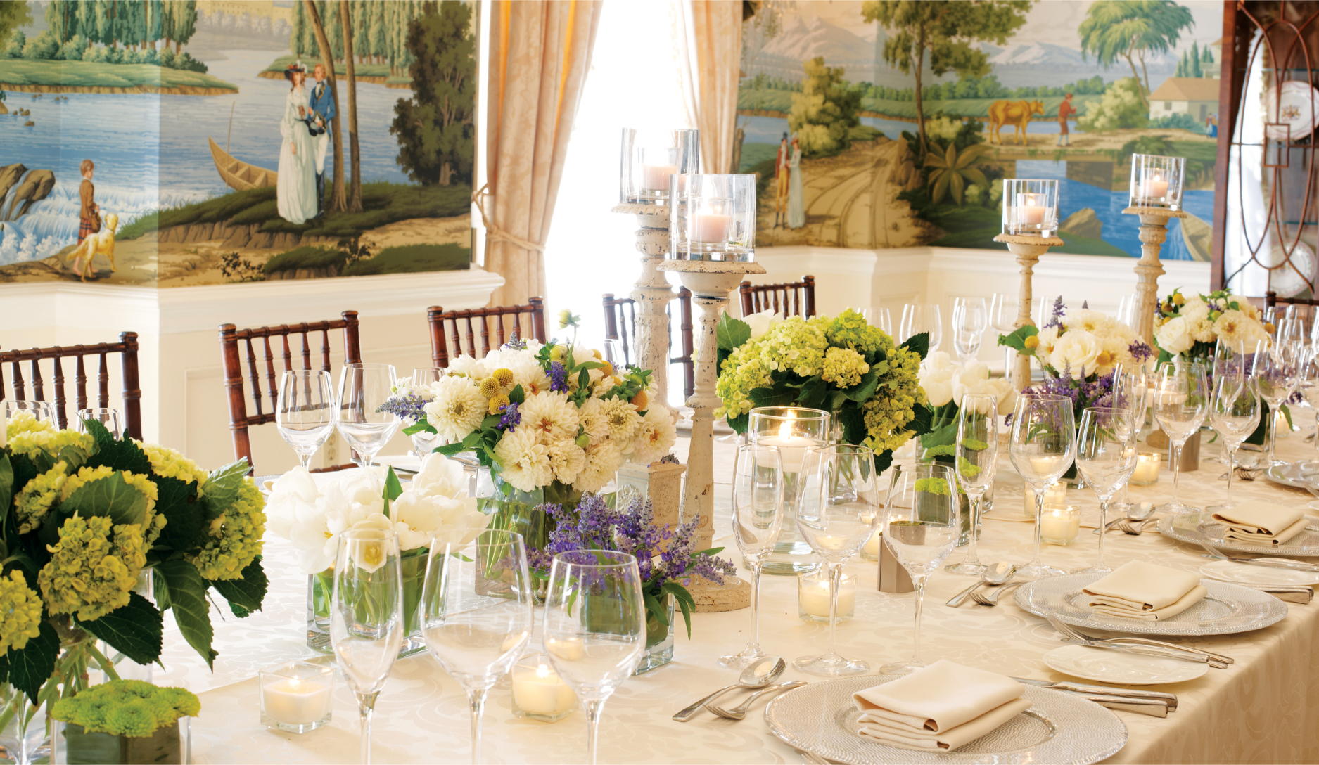 a formal dining table set with flowers and candles