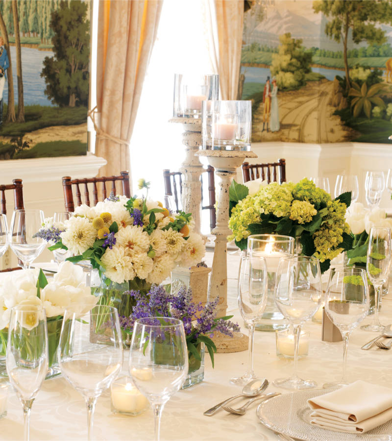 a formal dining table set with flowers and candles